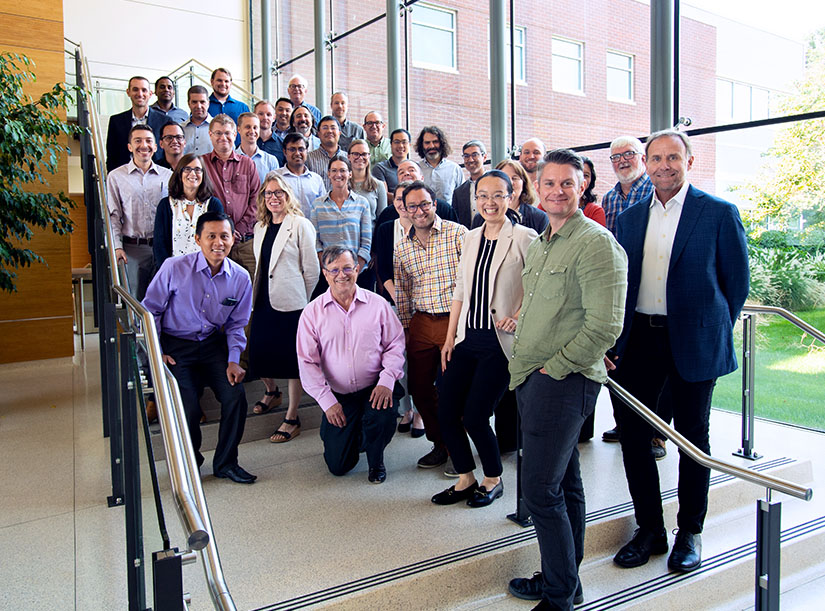 A large group of scientists pose for a group photo
