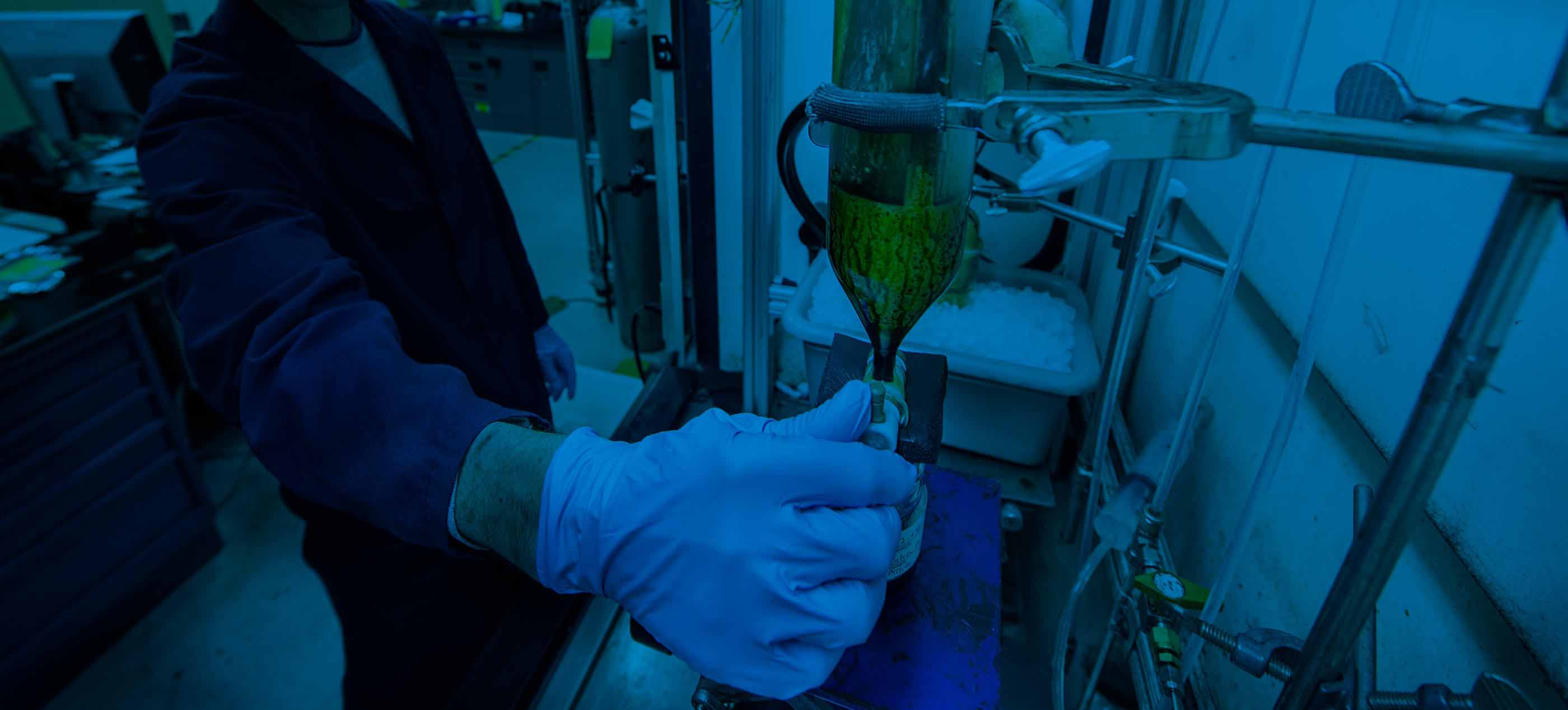 NREL technician works on catalytic fast pyrolysis oil production research.