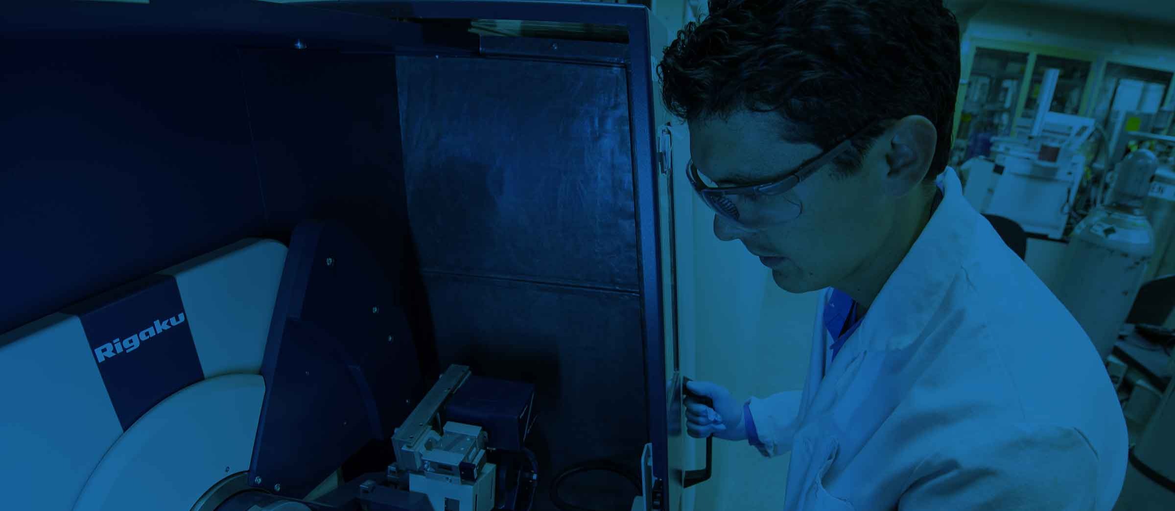 Man in a lab coat, working with equipment