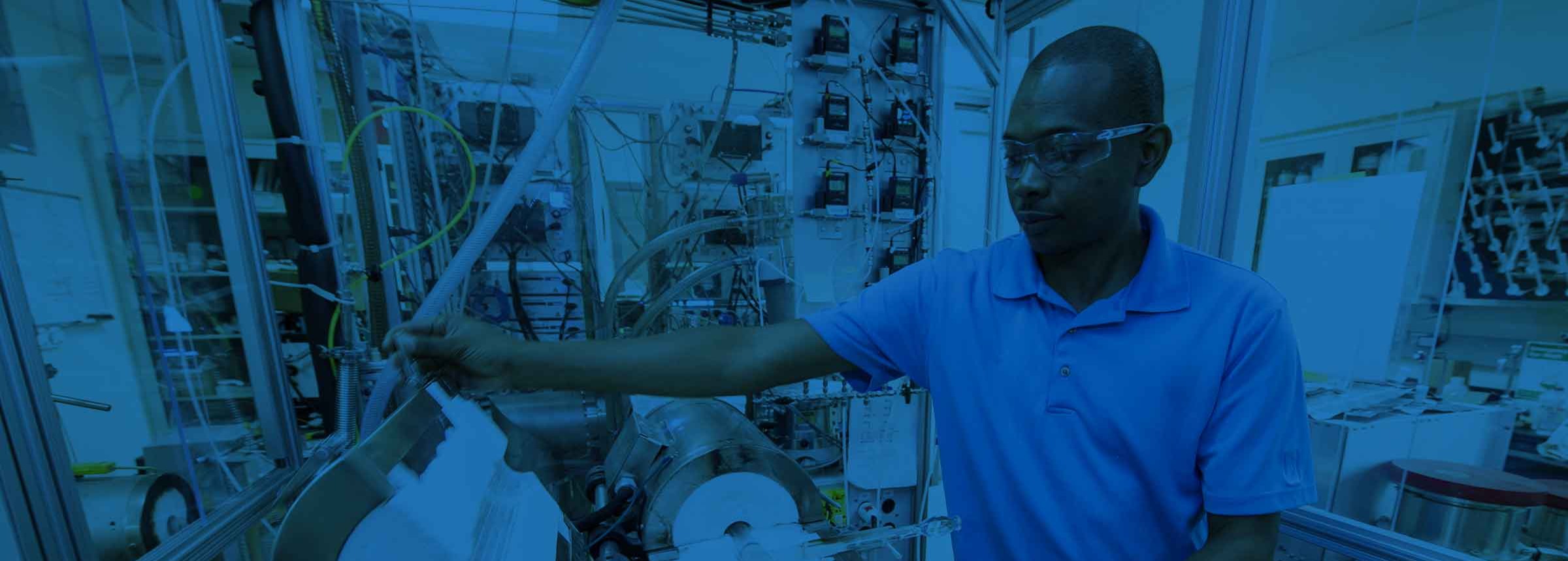 Man with goggles working on industrial equipment